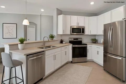 a kitchen with a sink stove and refrigerator