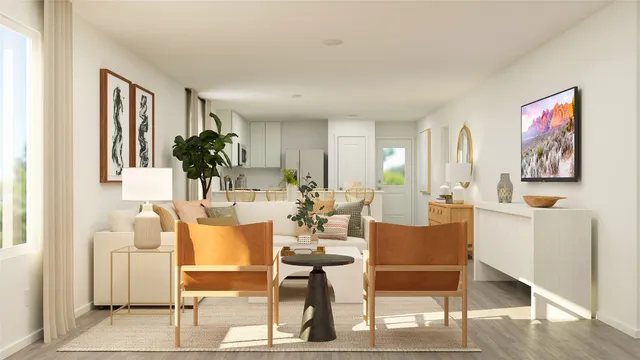 a view of a dining room with furniture one side kitchen view and wooden floor