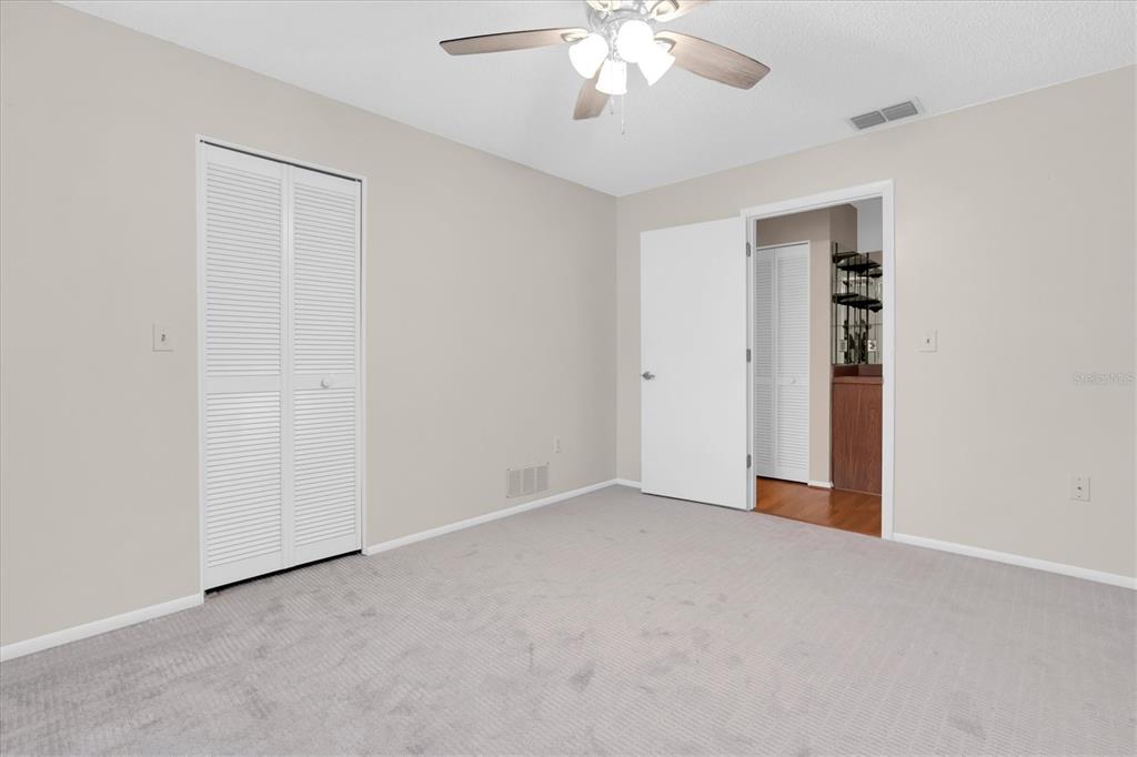 4814 Grist Mill Circle New Port Richey, FL 34655 - Photo 20 of 63 a view of an empty room with a chandelier fan