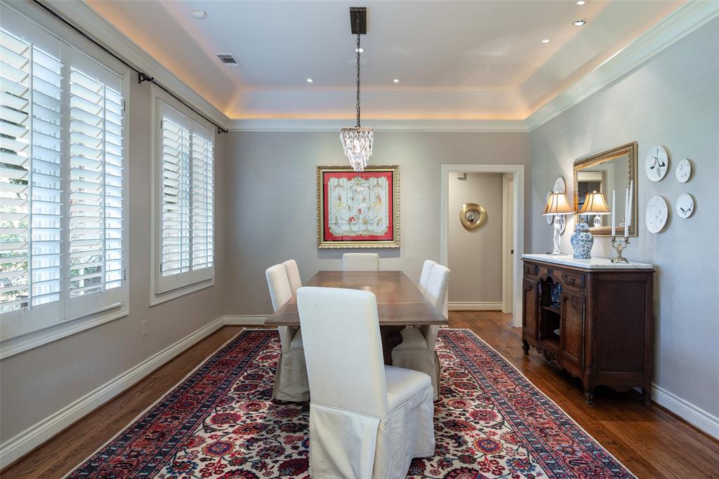 4422 Pomona Road Dallas, TX 75209 - Photo 13 of 34 a dining room with furniture a rug and a chandelier