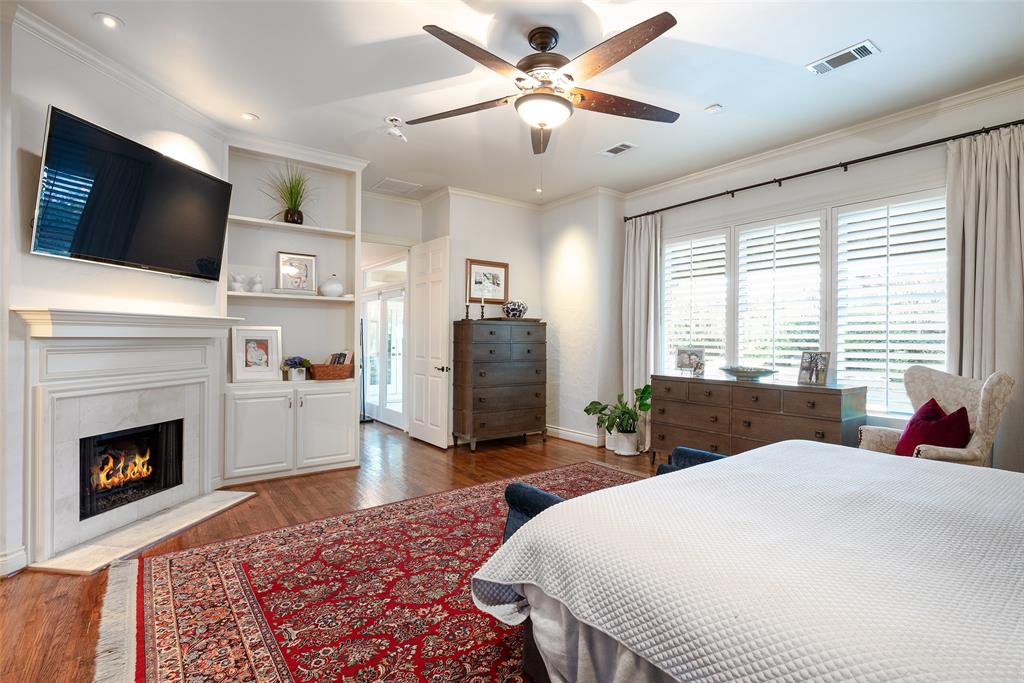 4422 Pomona Road Dallas, TX 75209 - Photo 16 of 34 a spacious bedroom with a bed and a flat screen tv