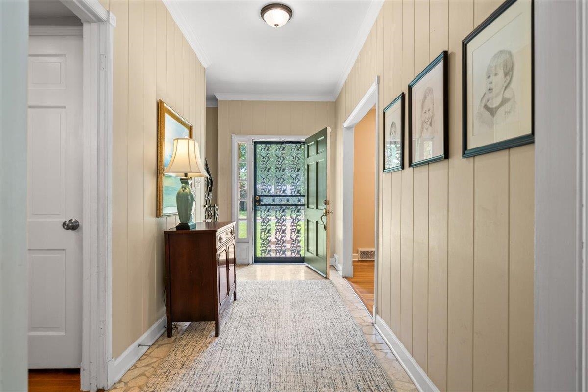 1273 Brookfield Road Memphis, TN 38119 - Photo 6 of 40 Entryway featuring vertical paneling, crown molding, and a decorative screen door