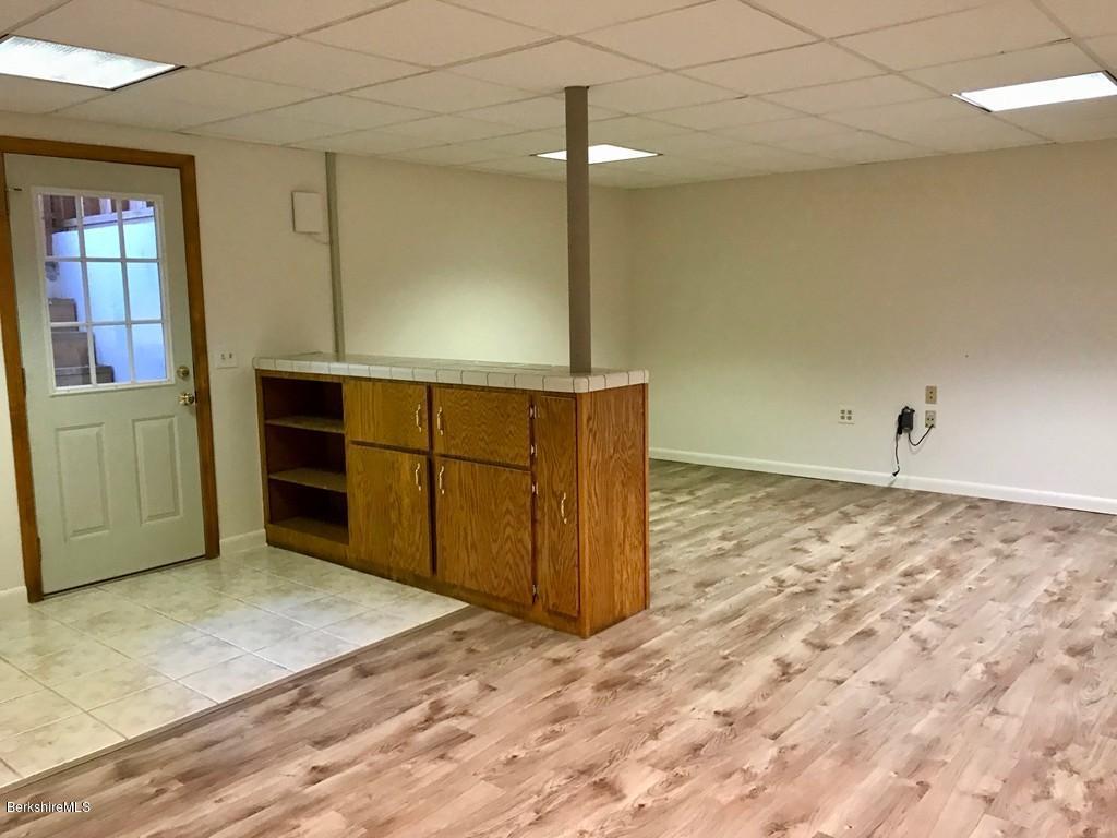 675 Patten Road Shelburne, MA 01370 - Photo 22 of 28 an empty room with a wooden cabinet and mirror