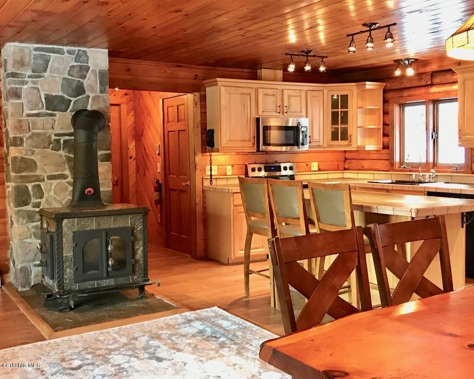 675 Patten Road Shelburne, MA 01370 - Photo 8 of 28 a kitchen with stainless steel appliances kitchen island granite countertop a stove a sink and a dining table