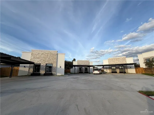 a view of a building with cars parked