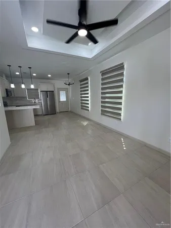 a view of a livingroom with a ceiling fan and window