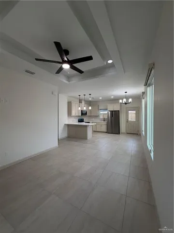 a view of a kitchen with a sink and a refrigerator