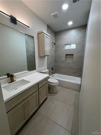 a bathroom with a double vanity sink toilet and shower