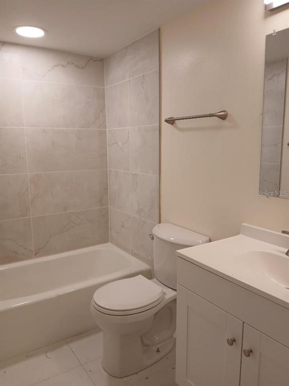 5787 Summerside Lane, Unit 4B Sarasota, FL 34231 - Photo 13 of 21 a bathroom with a sink a toilet and shower
