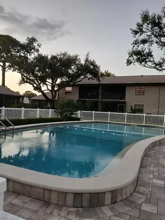a view of a swimming pool with a lounge chair