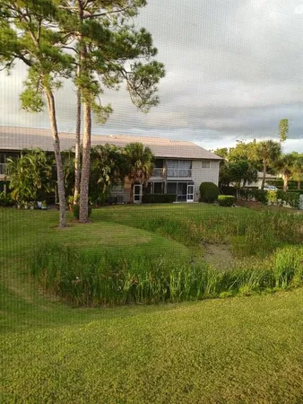 a view of a garden with a building in the background