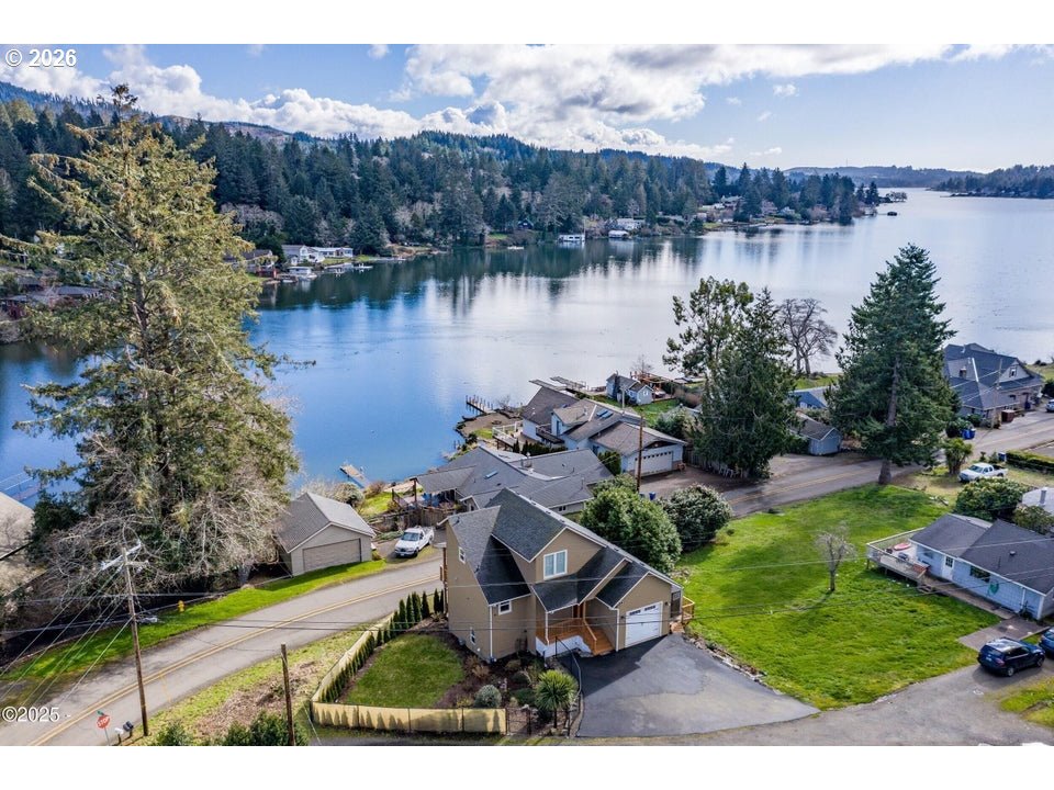 an aerial view of a house with garden space and lake view