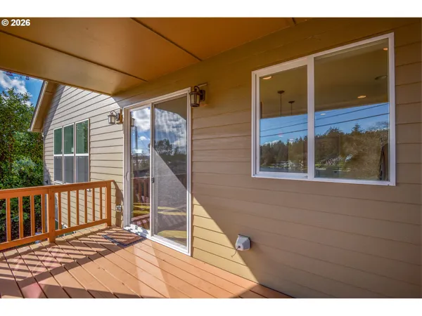 a view of a balcony with wooden floor and fence