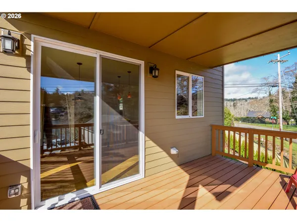 a view of a balcony with wooden floor and windows