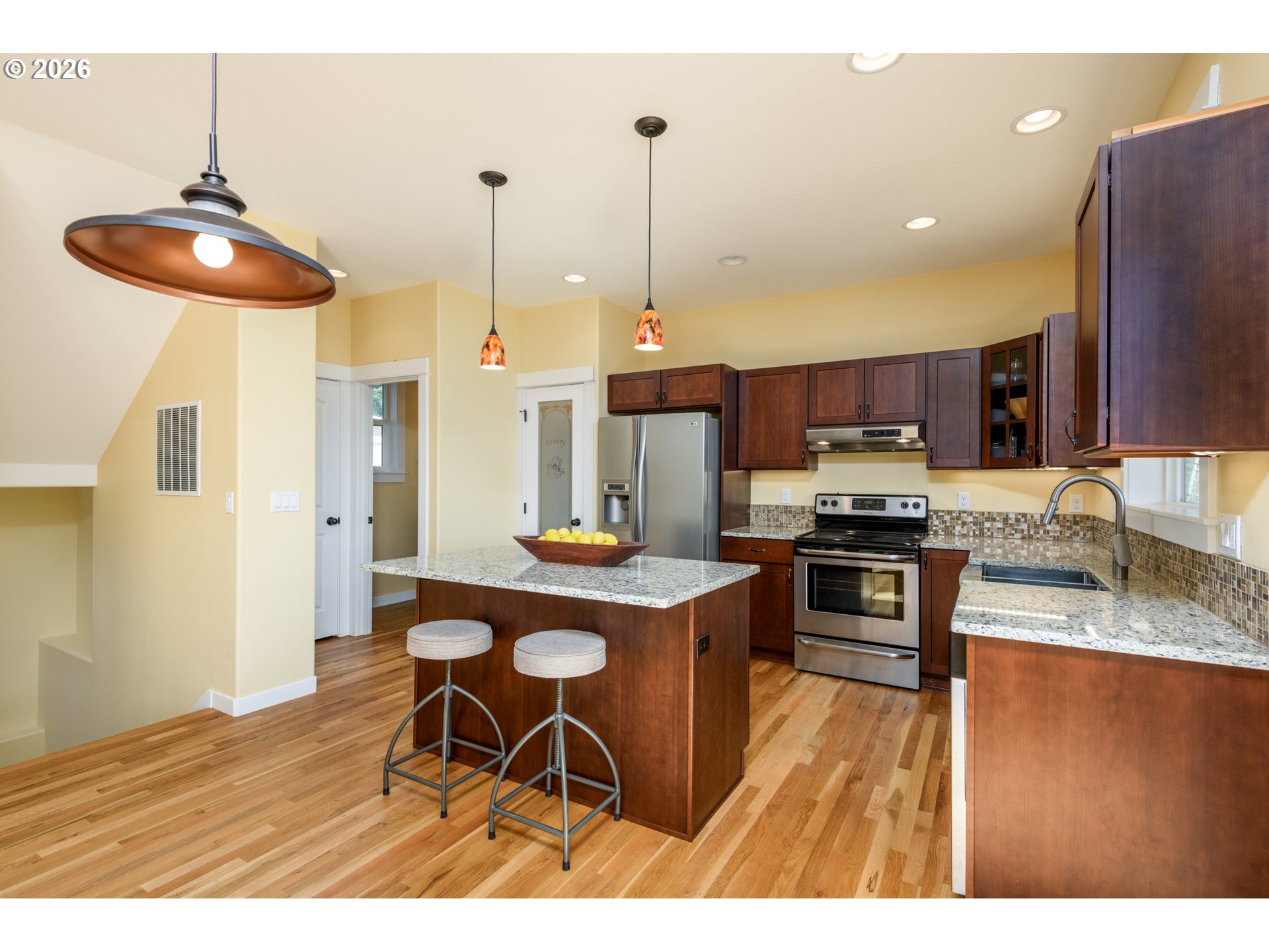 5300 Northeast 49th Street Neotsu, OR 97364 - Photo 19 of 48 a kitchen with kitchen island granite countertop stainless steel appliances a stove a sink a microwave oven with cabinets and wooden floor
