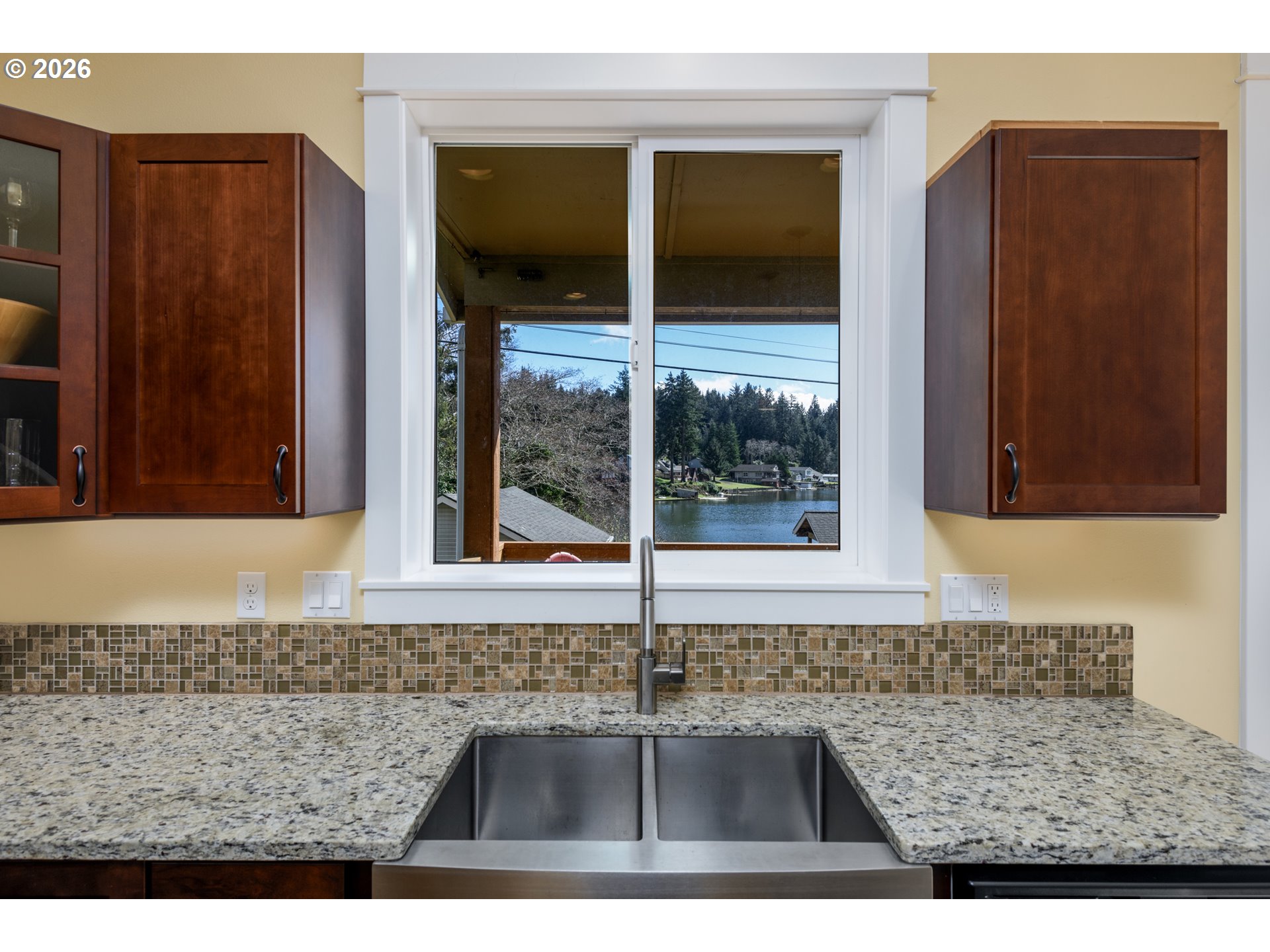 5300 Northeast 49th Street Neotsu, OR 97364 - Photo 24 of 48 a kitchen area with granite countertop sink and cabinets