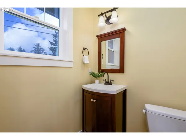 a bathroom with a toilet a sink and mirror