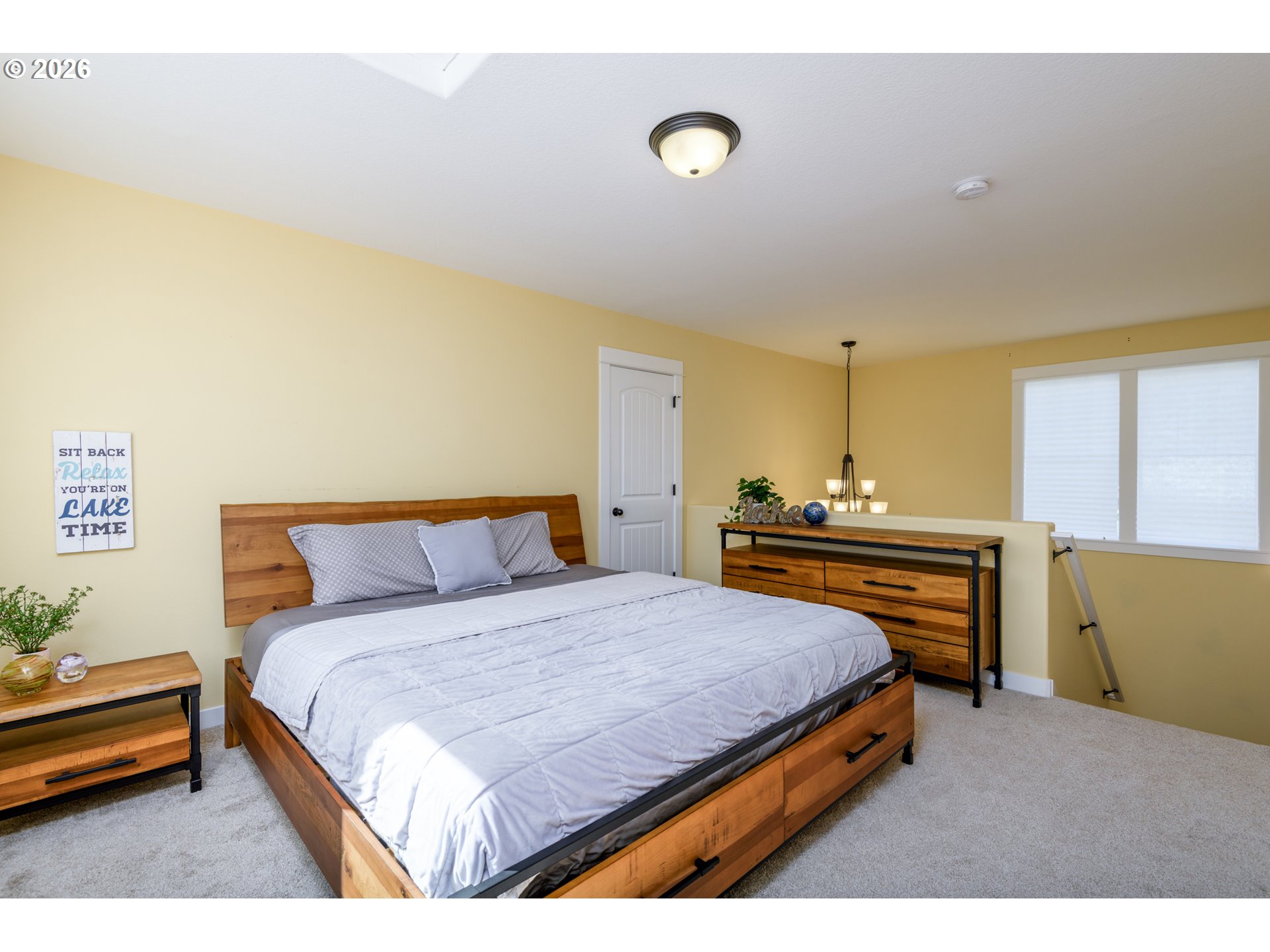 5300 Northeast 49th Street Neotsu, OR 97364 - Photo 29 of 48 a bedroom with a bed and dresser with wooden floor