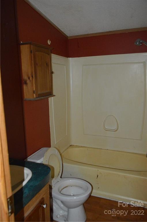 522 Gilreath Loop Road Mills River, NC 28759 - Photo 12 of 15 a bathroom with a granite countertop toilet and a sink