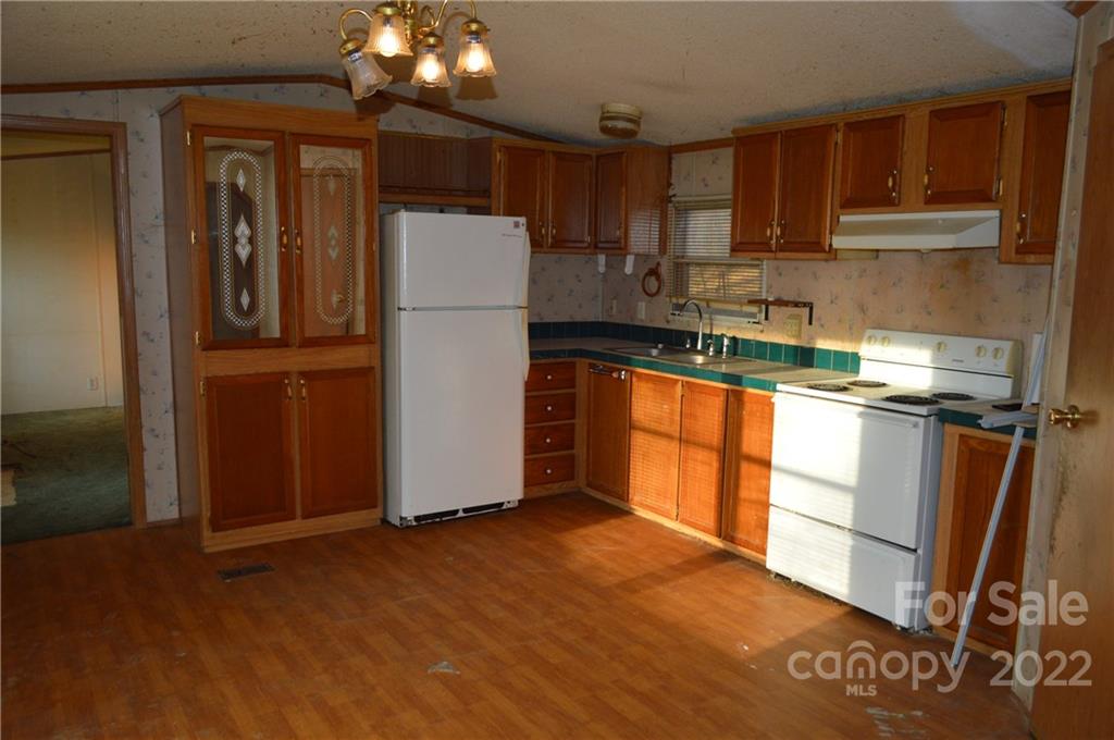 522 Gilreath Loop Road Mills River, NC 28759 - Photo 4 of 15 a kitchen with stainless steel appliances granite countertop a refrigerator sink and cabinets