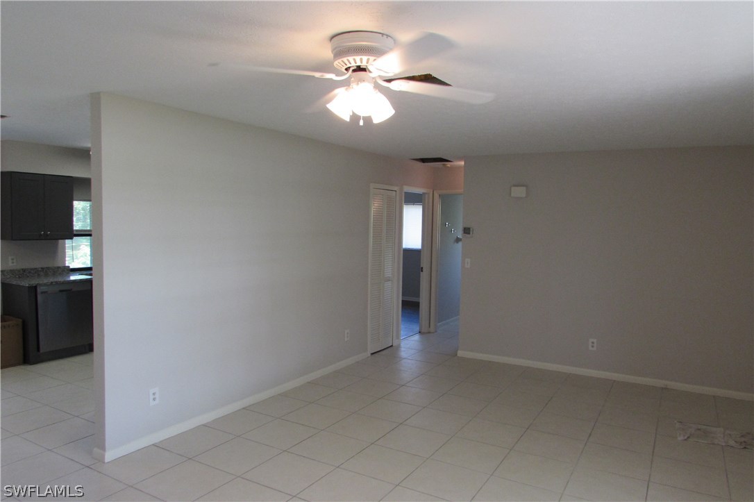 4983 18th Court Southwest Naples, FL 34116 - Photo 12 of 25 wooden floor in an empty room with a window