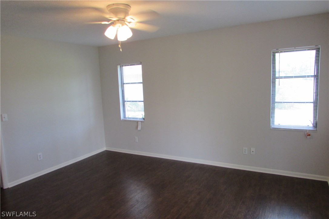 4983 18th Court Southwest Naples, FL 34116 - Photo 14 of 25 wooden floor in an empty room with a window