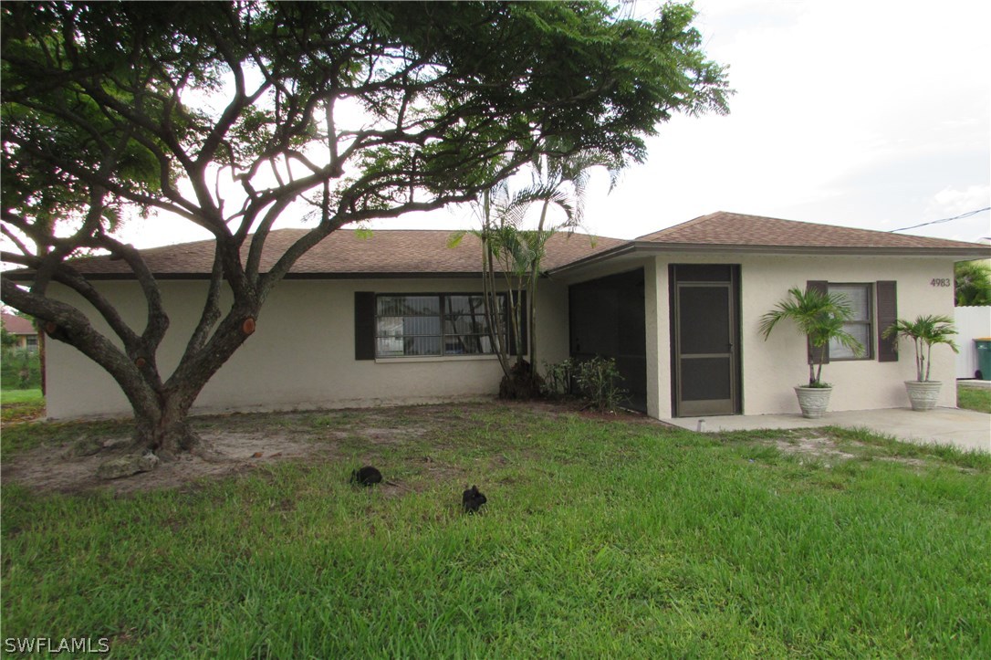 4983 18th Court Southwest Naples, FL 34116 - Photo 22 of 25 a view of a house with a yard