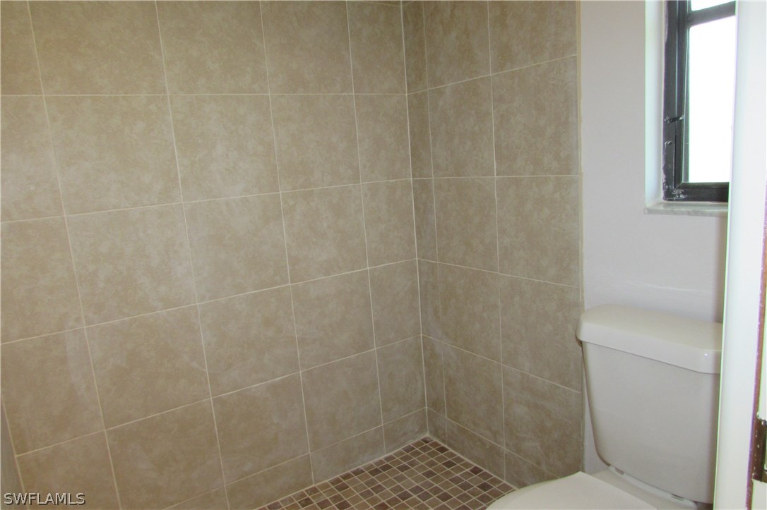 4983 18th Court Southwest Naples, FL 34116 - Photo 24 of 25 a bathroom with a shower
