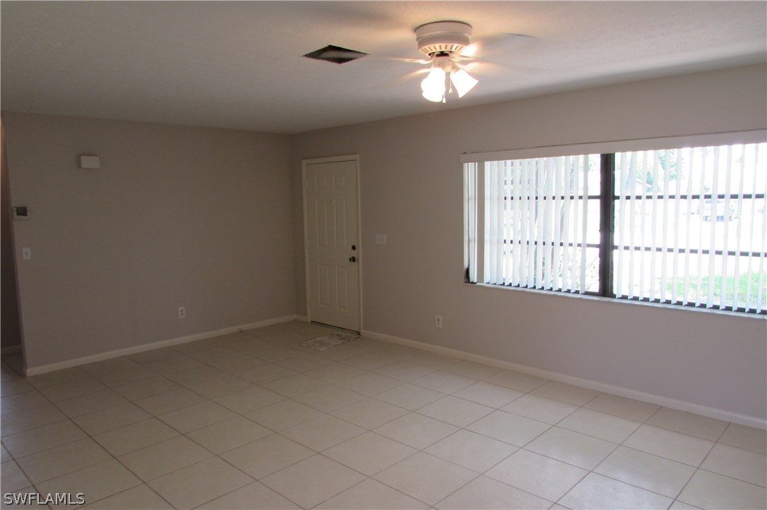 4983 18th Court Southwest Naples, FL 34116 - Photo 9 of 25 wooden floor in an empty room with a window