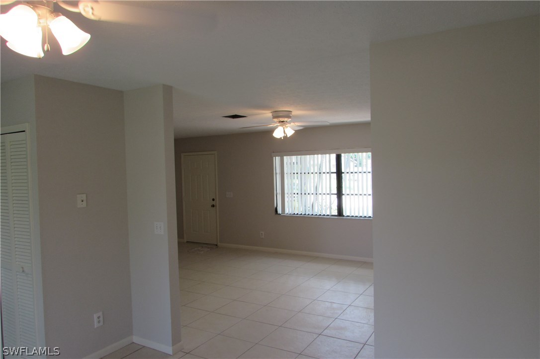 4983 18th Court Southwest Naples, FL 34116 - Photo 10 of 25 an empty room with windows and fan