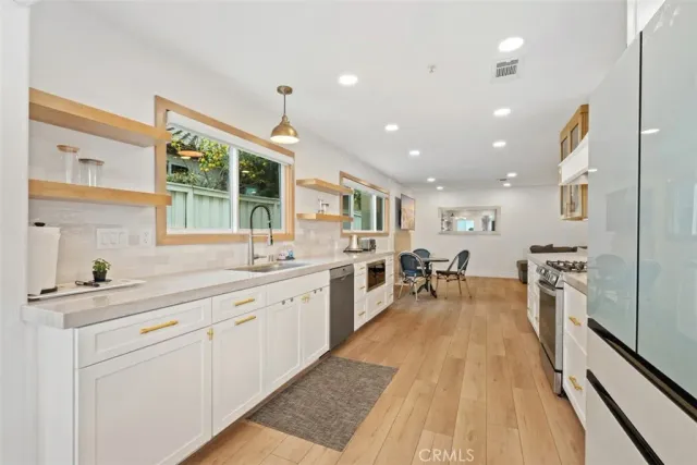 a large white kitchen with a large window