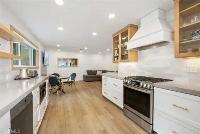 a kitchen with stainless steel appliances granite countertop a stove and a sink