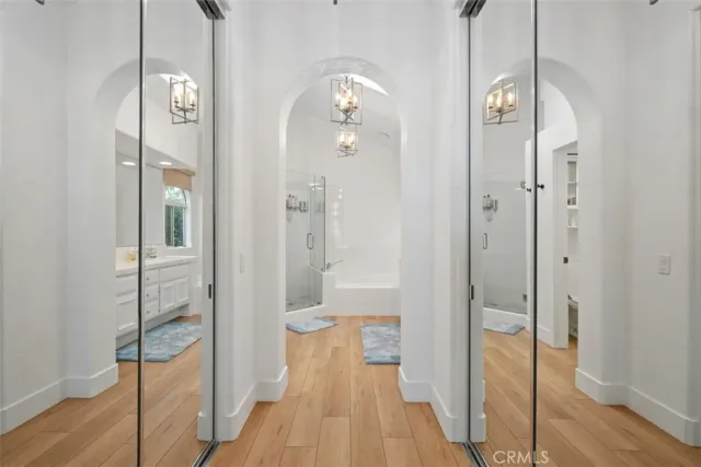a bathroom with a glass shower door and a sink