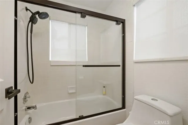 a bathroom with a shower and a toilet