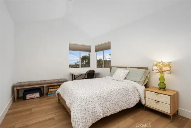 a bedroom with a bed and a night stand