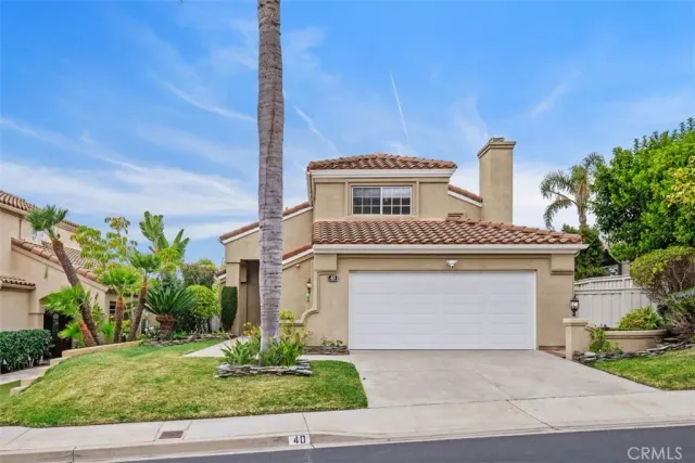 a front view of a house with a yard garage and outdoor seating