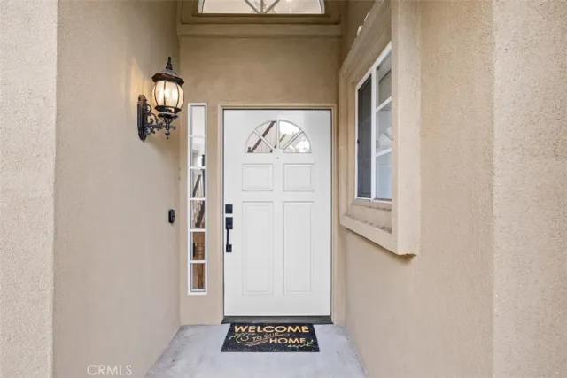 a view of hallway with a door and wooden floor