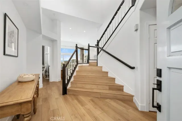 a view of entryway and hall with wooden floor