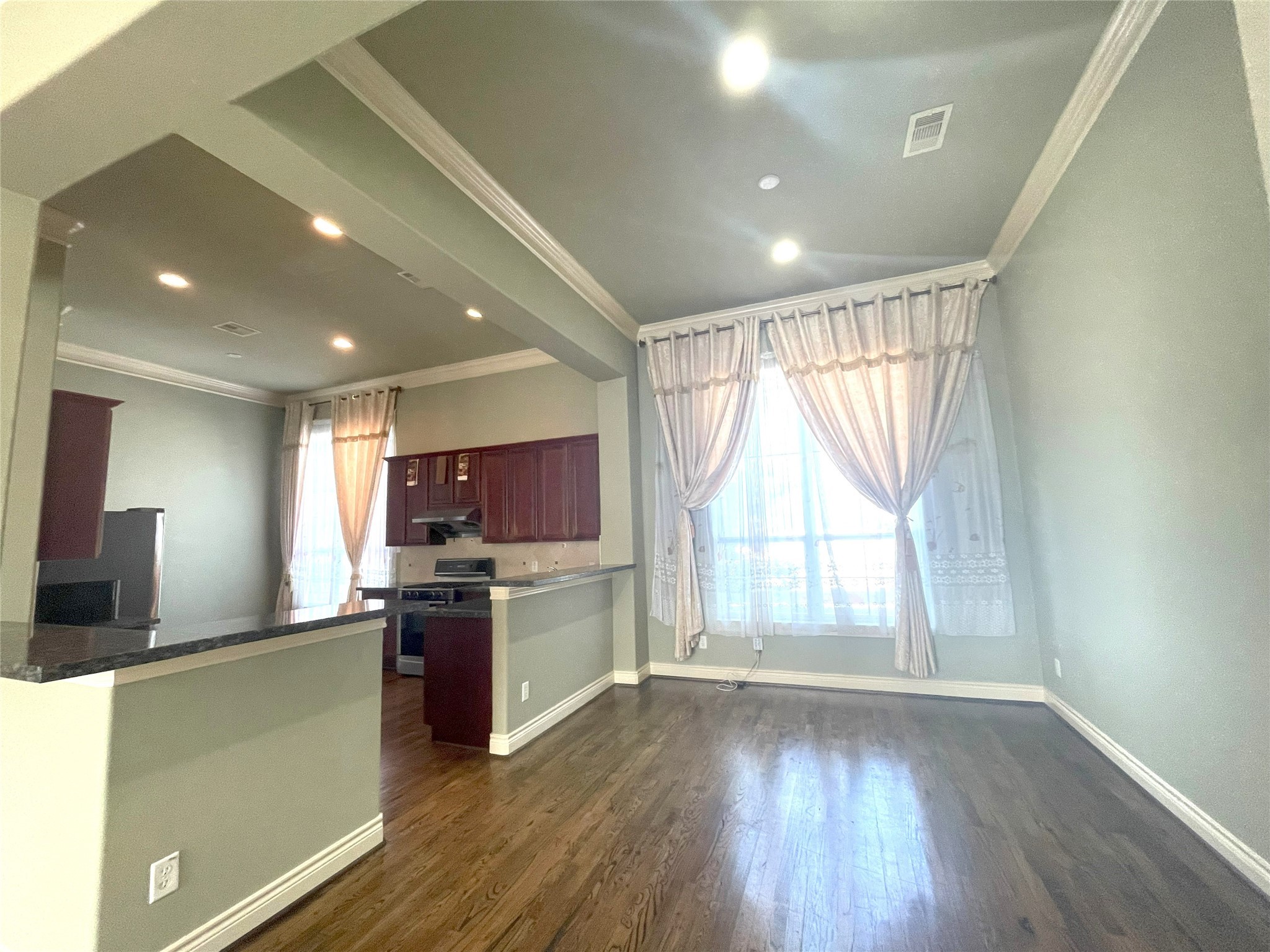3138 Pemberton Walk Houston, TX 77025 - Photo 18 of 27 a kitchen with stainless steel appliances granite countertop a refrigerator a sink dishwasher a stove and a large window with wooden floor
