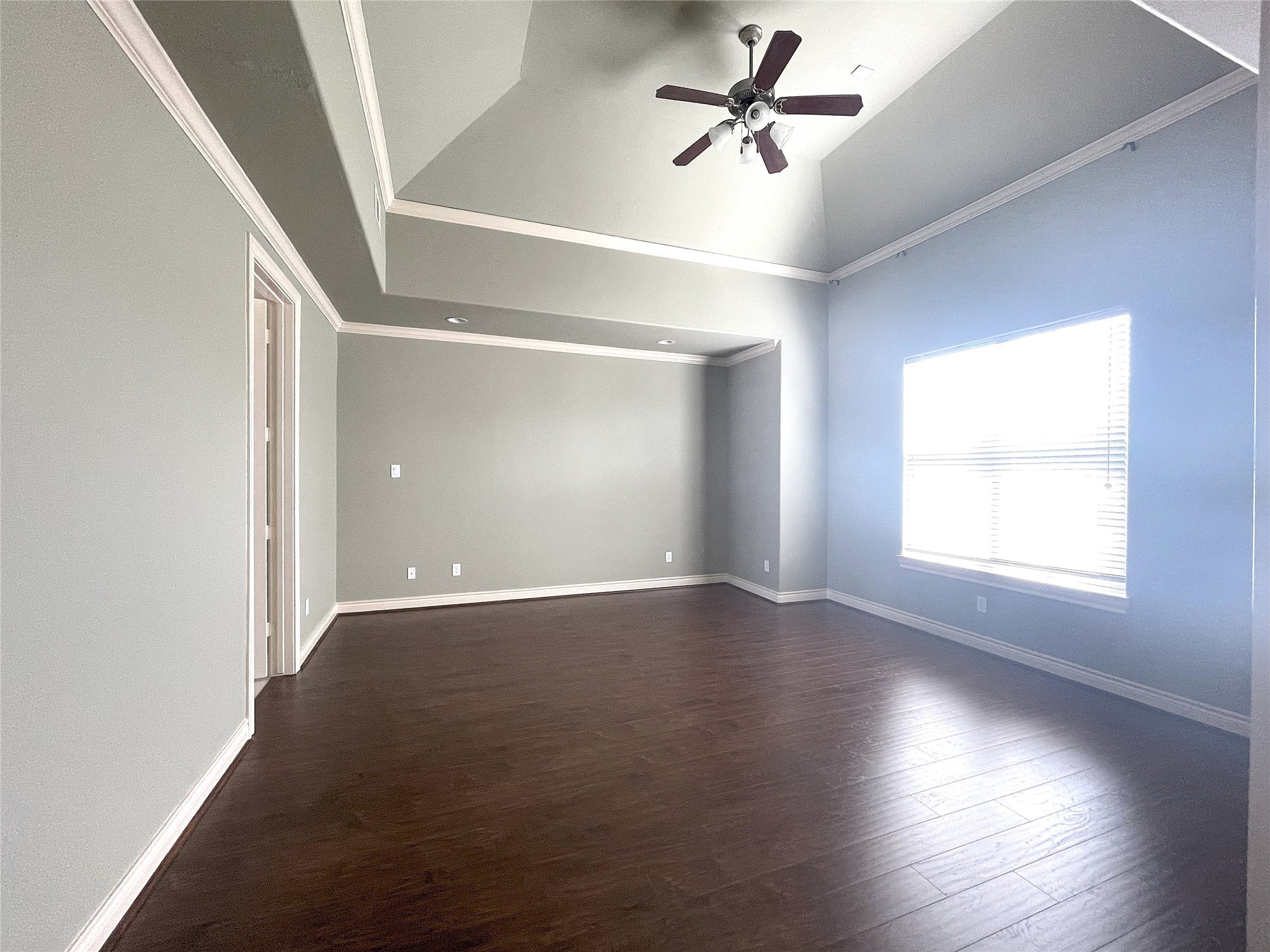 3138 Pemberton Walk Houston, TX 77025 - Photo 20 of 27 an empty room with wooden floor fan and windows