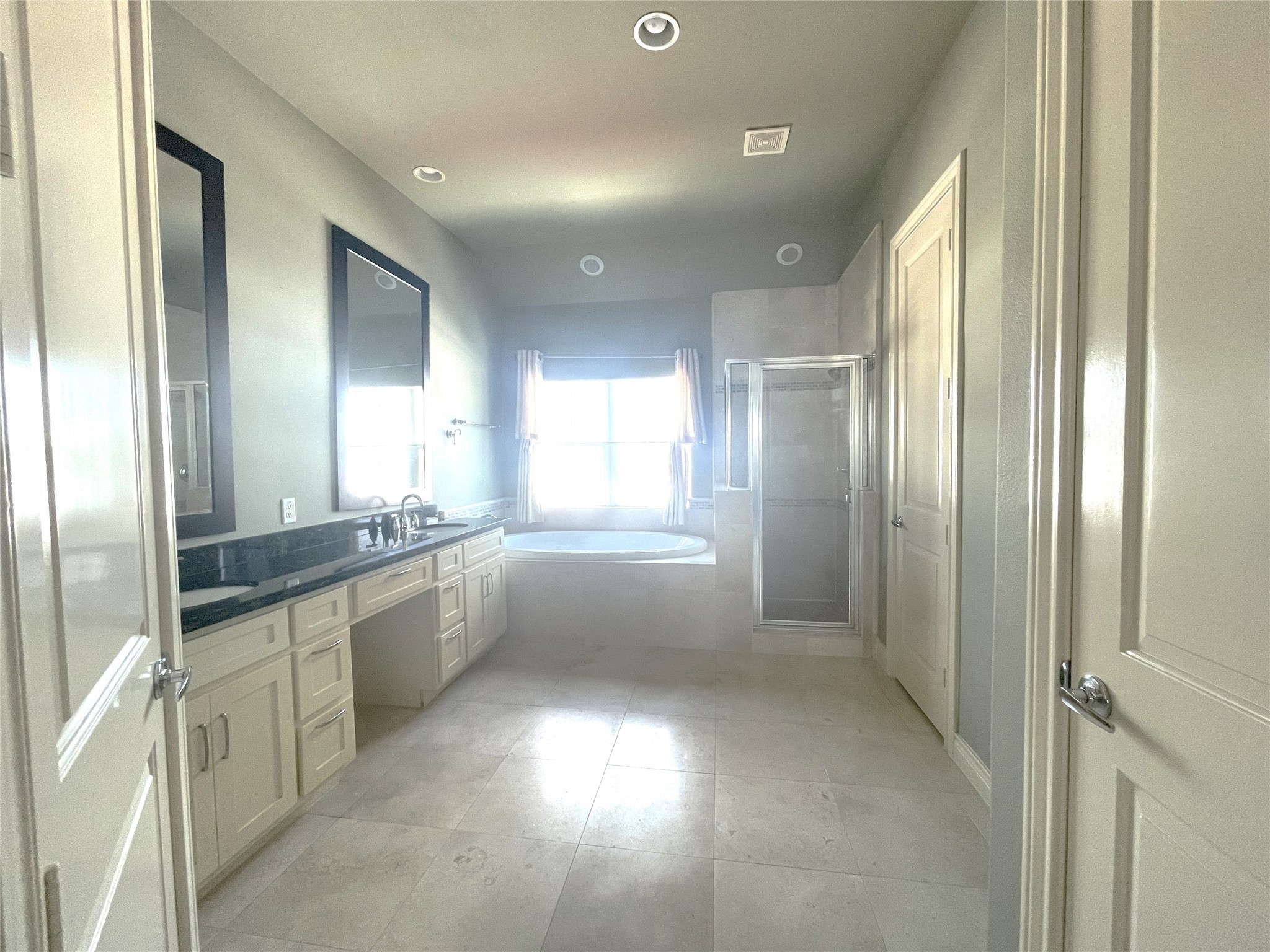 3138 Pemberton Walk Houston, TX 77025 - Photo 22 of 27 a large bathroom with a large mirror vanity and shower