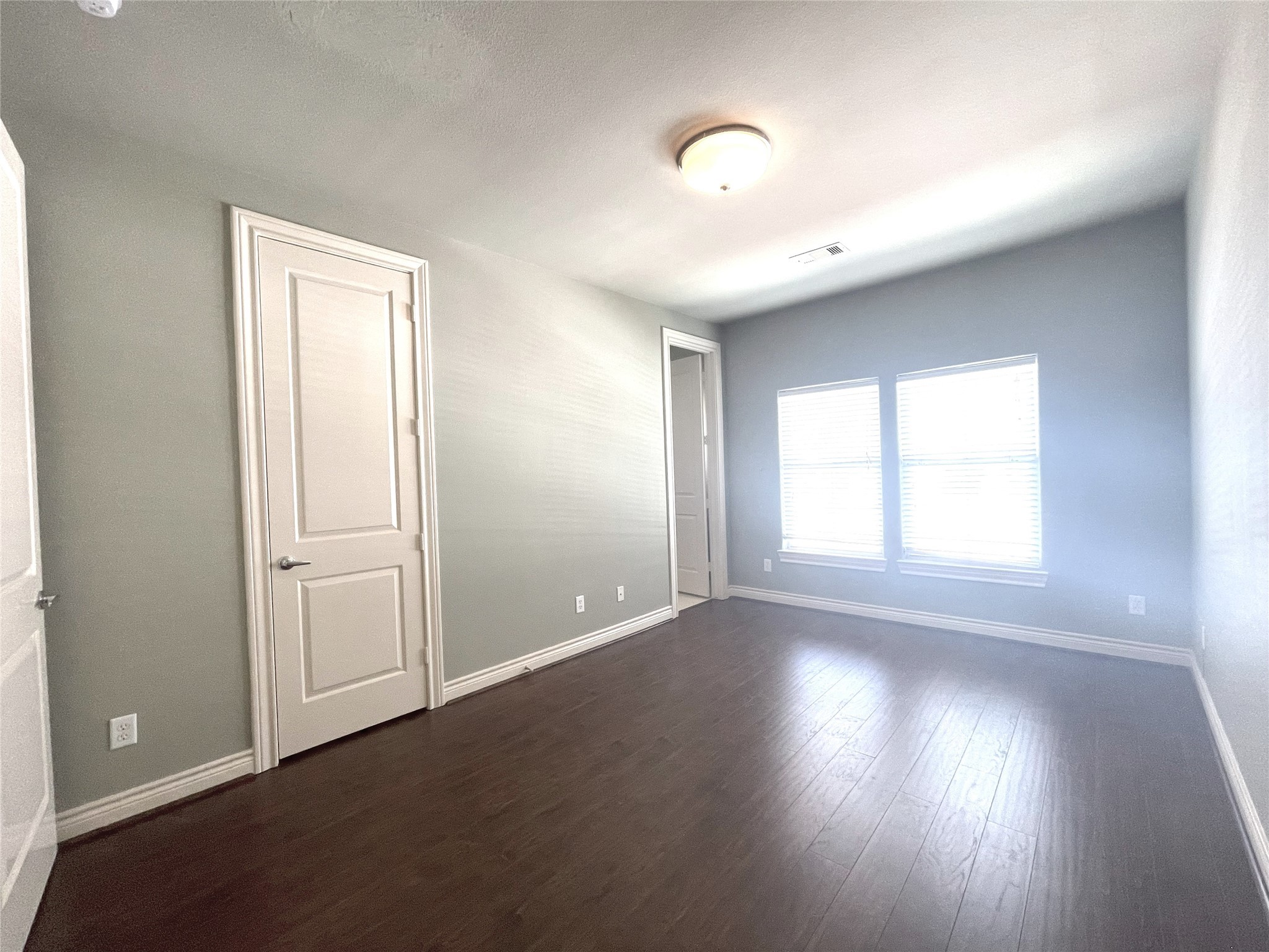 3138 Pemberton Walk Houston, TX 77025 - Photo 23 of 27 an empty room with wooden floor and windows