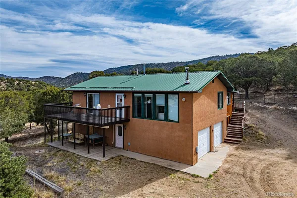a view of a house with backyard and sitting area