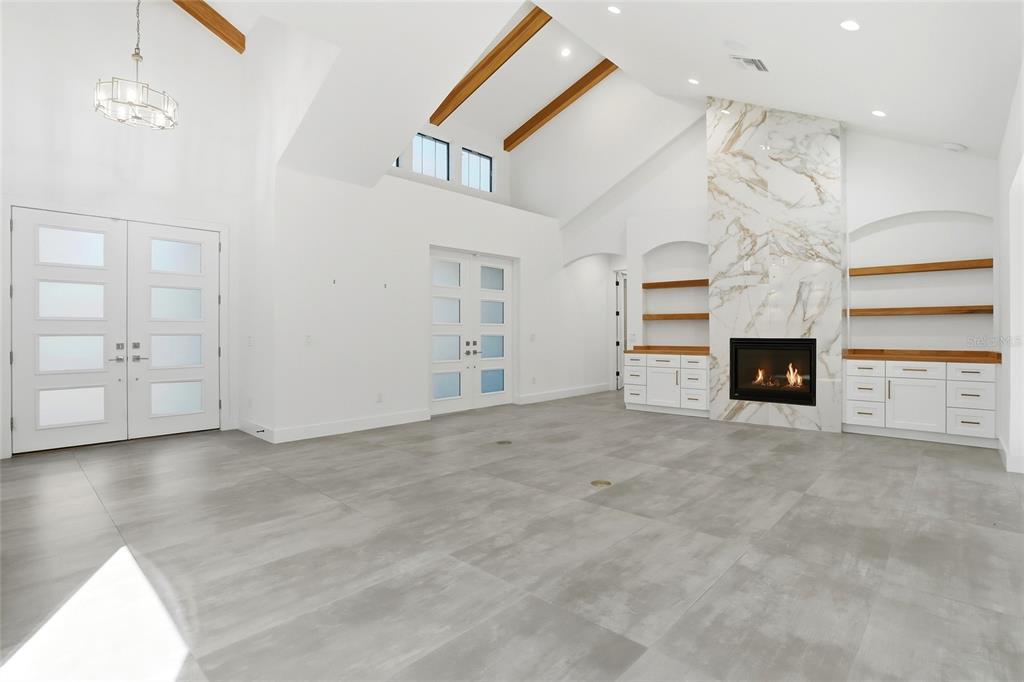 16728 Bearle Road Orlando, FL 32828 - Photo 12 of 72 an empty room with fireplace and windows