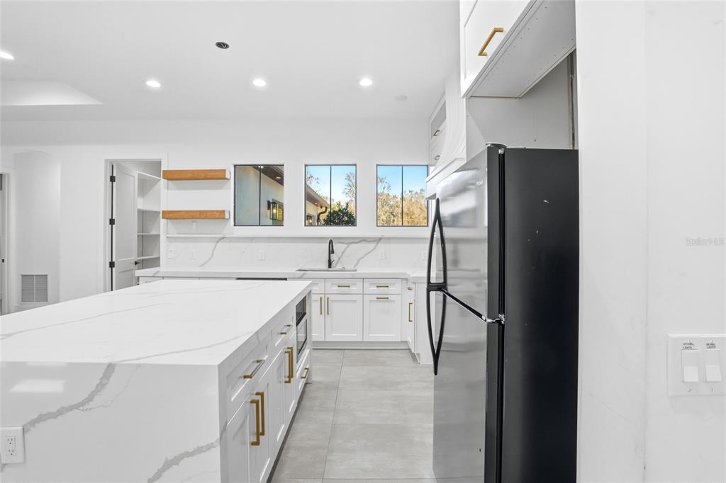 16728 Bearle Road Orlando, FL 32828 - Photo 14 of 72 a kitchen with a refrigerator and a sink