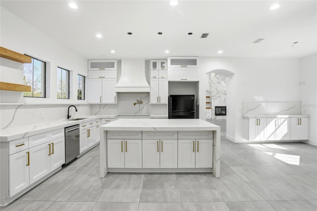16728 Bearle Road Orlando, FL 32828 - Photo 16 of 72 a kitchen with a stove top oven and cabinets