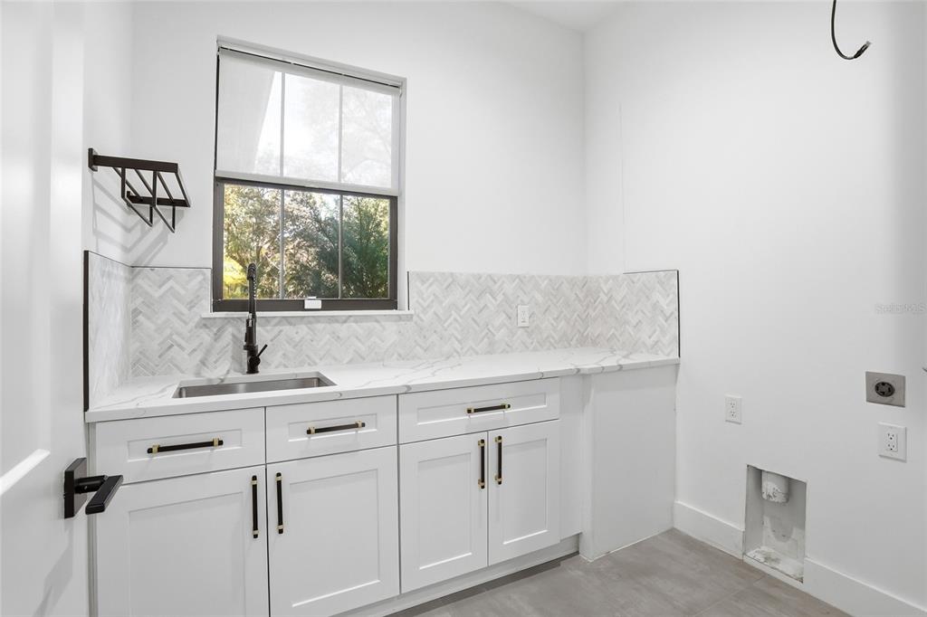 16728 Bearle Road Orlando, FL 32828 - Photo 20 of 72 a bathroom with a sink and a window