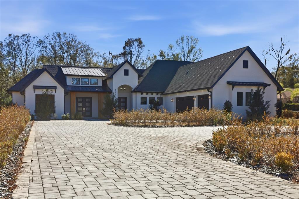 16728 Bearle Road Orlando, FL 32828 - Photo 3 of 72 a front view of a house with a yard
