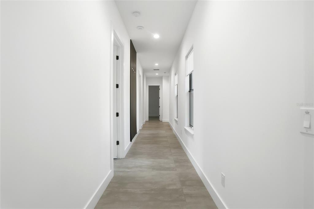 16728 Bearle Road Orlando, FL 32828 - Photo 32 of 72 a view of a hallway with wooden shelves