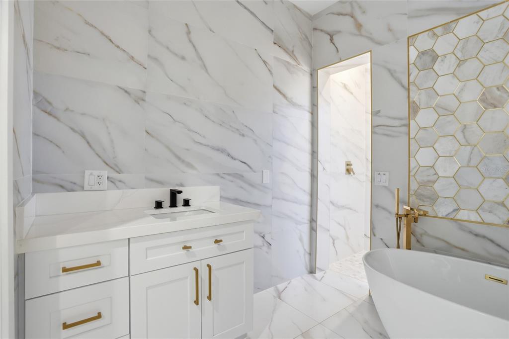 16728 Bearle Road Orlando, FL 32828 - Photo 45 of 72 a bathroom with a sink and a bathtub